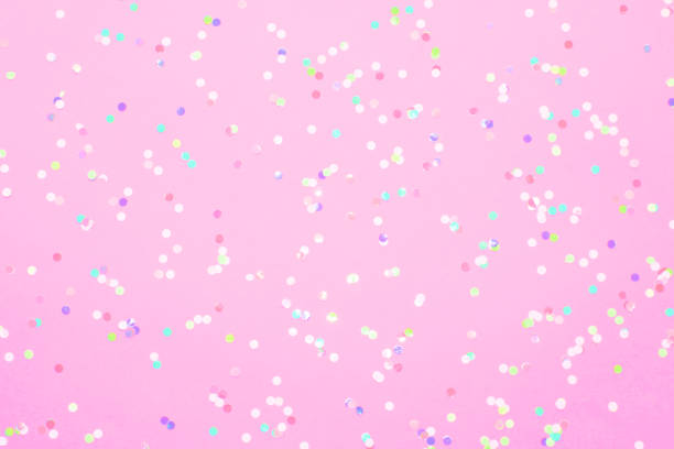 istock Colored confetti scattered on pink pastel paper 1166583352