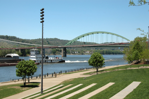 Tug boat and barge just after clearing the National Road bridge on the Ohio River at Wheeling, West Virginia