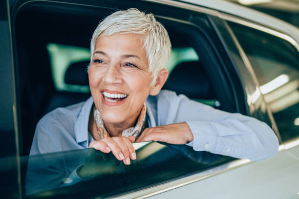 istock Beautiful mature woman in a car 1166584111