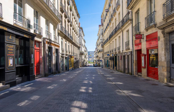 Pedestrian shopping street with luxury fashion stores in downtown of Nantes, France Nantes, France - May 12, 2019: Pedestrian shopping street with luxury fashion stores in downtown of Nantes, France nantes stock pictures, royalty-free photos & images