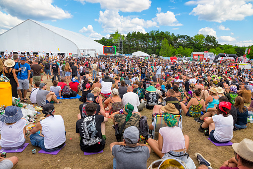 Kostrzyn Nad Odra, Poland - August 03 2019: Before the concerts, hundreds of people spend their time listening to interesting people invited to the Academy of gorgeous arts as guests of the 25th Pol'and'rock Festival - the biggest open air ticket free rock music festival in Europe