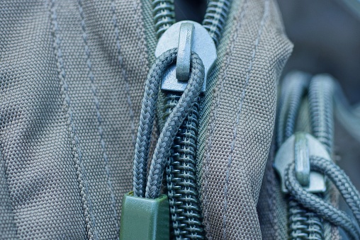 one green gray metal zip on the backpack