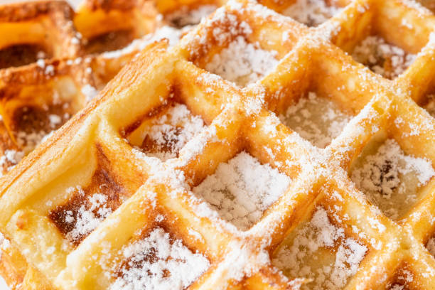 istock Belgian waffles sweet background with powdered sugar on top 1166588153