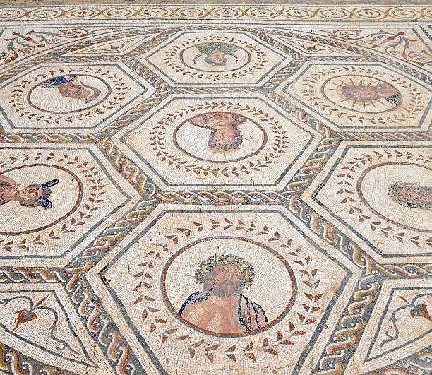 Roman mosaics,Italica Archaeological Complex,Spain The Roman city of Italica has its origins in the year 206 BC. This ancient mosaic floor in the House of the Planetarium, represents  the seven planetary divinities related to the days of the week.Picture was taken outside in a public place. italica spain stock pictures, royalty-free photos & images