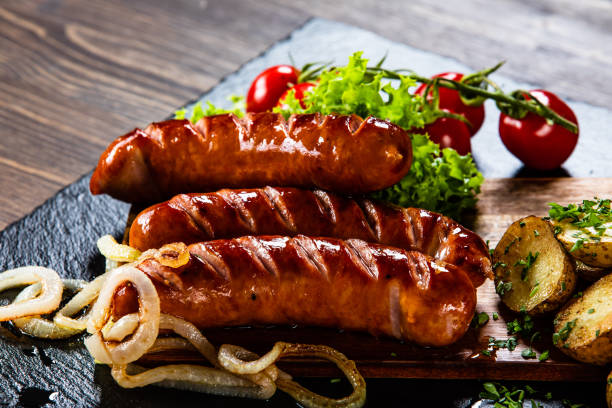 istock Grilled sausages with baked potatoes and vegetables 1166589040