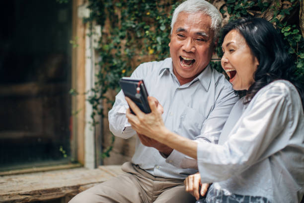 istock Senior couple using smart phone together 1166589379