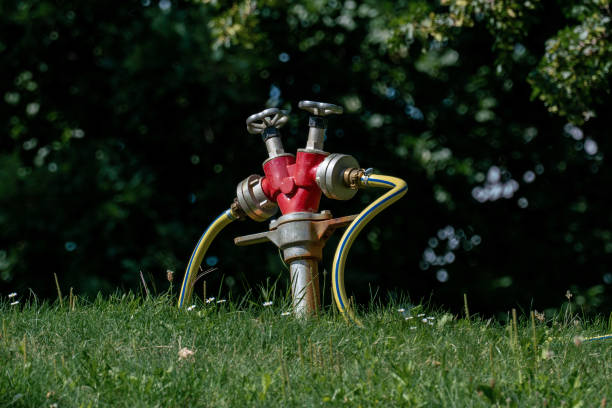 Professional irrigation system for public green areas and parks consisting of double tapping point and water hose for watering large areas of plants or gras