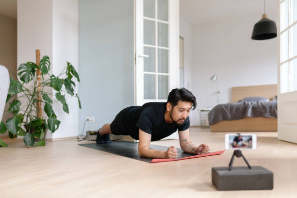 istock Asian fitness vlogger does a plank pose at home 1166589477