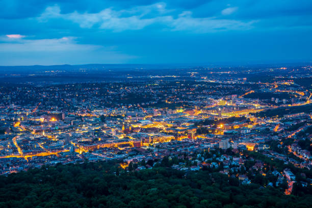 Germany, Illuminated night lights of downtown stuttgart city from above aerial perspective in summer stock photo