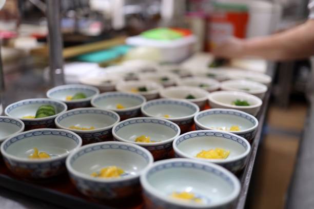 istock Cook serving foods in bowls at kitchen 1166592144