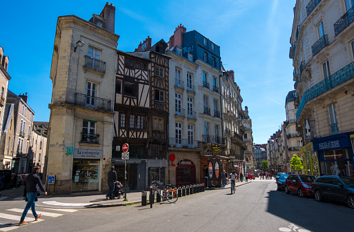 Nantes, France - May 12, 2019: Busy street with old houses in downtown of Nantes, France