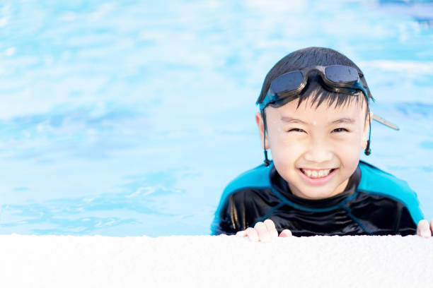 istock Happy little boy swimming in a pool 1166592457