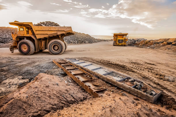 istock Large Yellow Dump Tip Trucks for transporting Platinum and Palladium Ore rocks 1166593687
