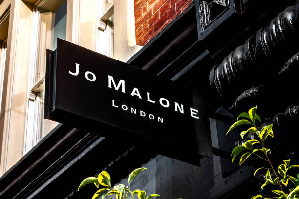 Luxury perfume and fashion brand Jo Malone brand logo on a sign in the storefront in the iconic Covent Garden in London, England London, UK - August 1st 2018: Luxury perfume and fashion brand Jo Malone brand logo on a sign in the storefront in the iconic Covent Garden in London, England jo malone stock pictures, royalty-free photos & images