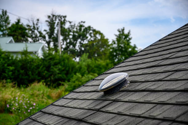 Dome shaped solar tube skylight on asphalt shingle roof