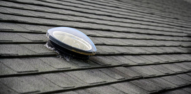 istock Dome shaped solar tube skylight on asphalt shingle roof 1166598012