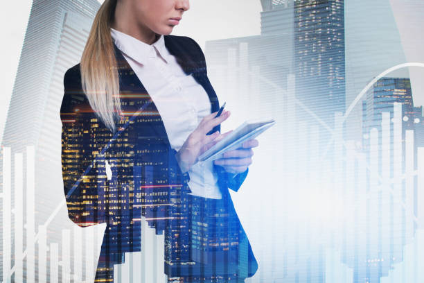 istock Blonde businesswoman writing report, graphs 1166598277