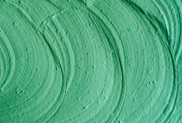 istock Green cosmetic clay (facial mask, cream, body wrap) texture close up, selective focus. Abstract background with brush strokes. 1166598584