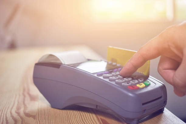 istock hand using credit card swiping machine entering credit card code to pay shopping online.creditcard swipe through terminal for payment in shop,buy and sell products & service,internet of things,vintage 1166599888