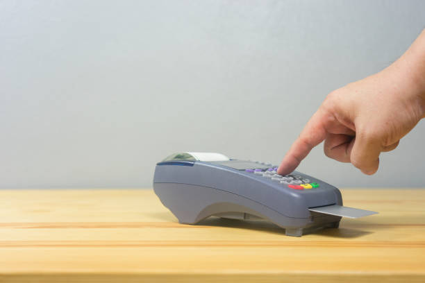 istock hand using credit card swiping machine entering credit card code to pay shopping online.creditcard swipe through terminal for payment in shop,buy and sell products & service,internet of things,vintage 1166599965