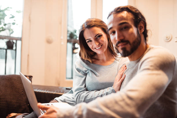 istock sensual couple using the laptop at home 1166601411