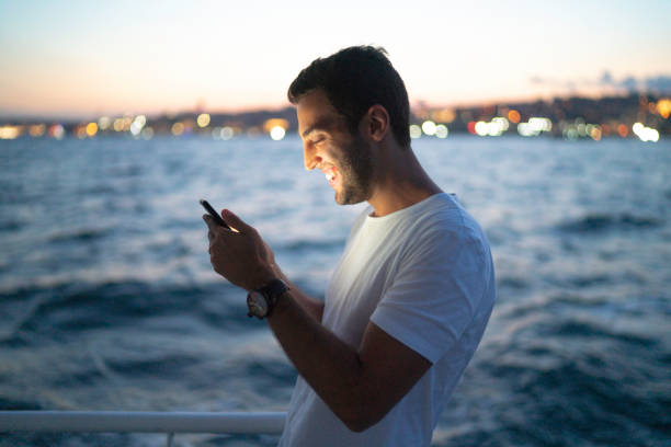 istock Side view of a man making a video chat at a boat 1166603718