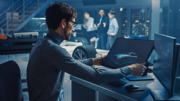 istock Professional Automotive Graphic Designer is Working on Concept Car Render with a Stylus Pen in a High Tech Innovative Laboratory with a Prototype Car Chassis. 1166603937