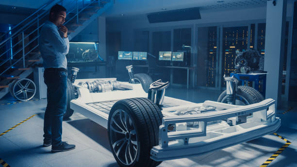 istock Automobile Design Engineer in Automotive Innovation Facility and Working on Electric Car Platform Chassis Prototype that Includes Wheels, Suspension, Hybrid Engine and Battery. 1166603966