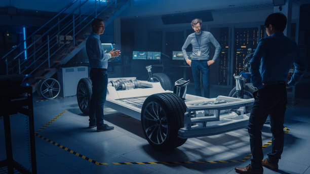 istock Diverse Team of Automobile Design Engineers Working Automotive Innovation Facility on Electric Car Platform Chassis Prototype that Includes Wheels, Suspension, Hybrid Engine and Battery 1166603967