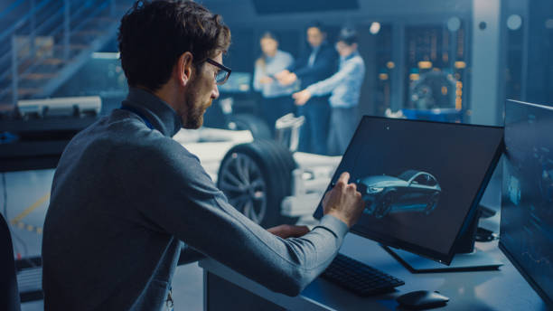 istock Professional Automotive Graphic Designer is Working on Concept Car Render with a Stylus Pen in a High Tech Innovative Laboratory with a Prototype Car Chassis. 1166603968