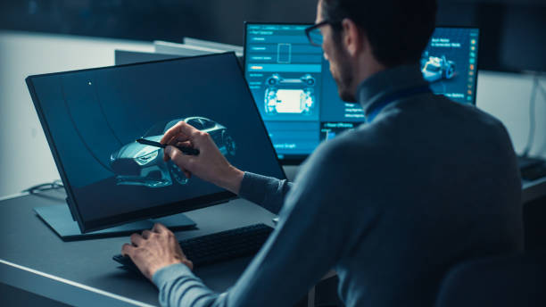 istock Professional Automotive Graphic Designer is Working on Concept Car Render with a Stylus Pen in a High Tech Innovative Laboratory with a Prototype Car Chassis. 1166604023