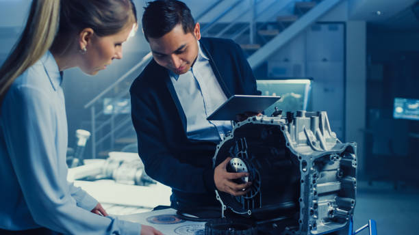 istock Development Laboratory Room with Professional Automotive Design Engineer Working on a Electric Car Gear Transmission. Chassis with Wheels, Batteries, Engine and Suspension. 1166605236