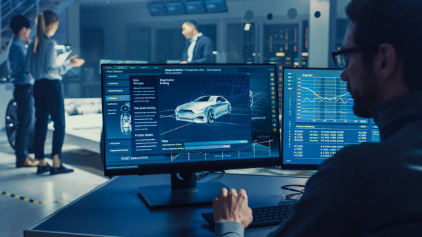 istock Professional Engineer Works on a Computer with a 3D CAD Software and Tests the Electric Car Chassis Prototype with Wheels, Batteries and Engine Standing in a High Tech Development Laboratory. 1166605239