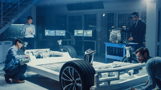 istock Automotive Design Engineers Work and Do Tests on Electric Car Chassis Prototype. In Innovation Laboratory Facility Concept Vehicle Frame Includes Wheels, Suspension, Engine and Battery. 1166605271
