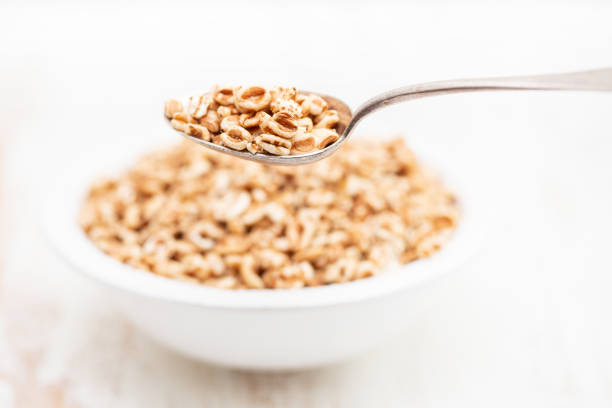 istock puffed spelt in white bowl on wooden background 1166605626