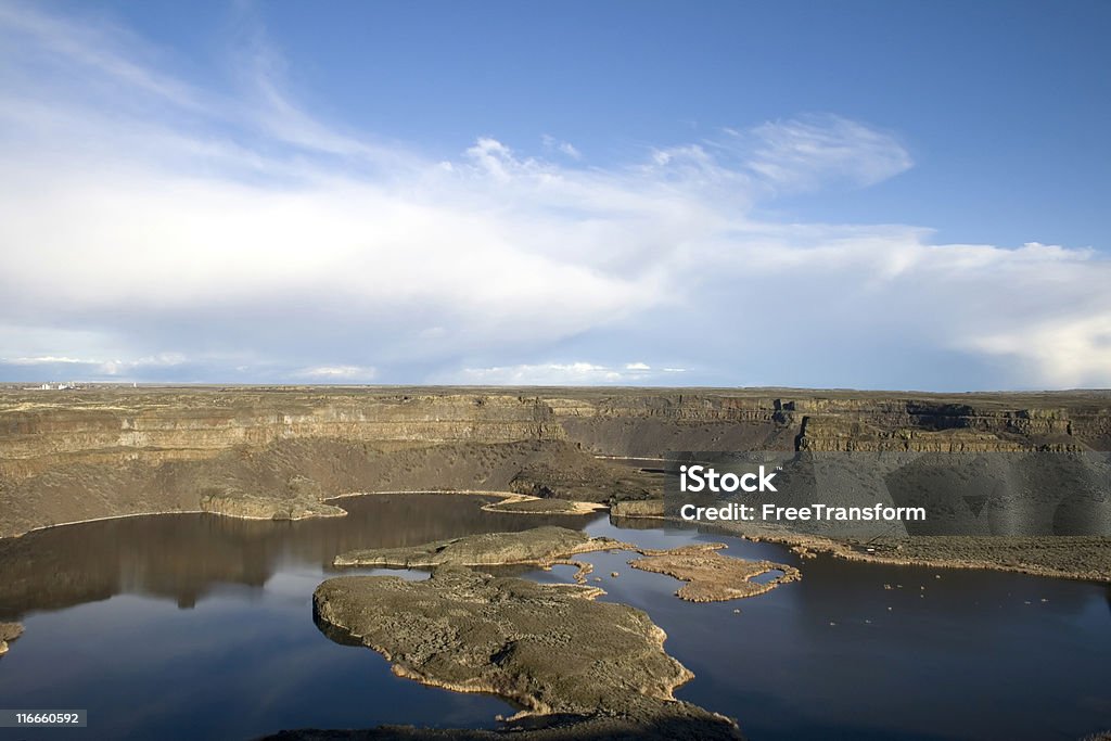 Dry Falls Washington The three-and-a-half mile crescent-shaped precipice known as Dry Falls, in central Washington. Ten times the size of Niagara, Dry Falls is thought to be the greatest known waterfall that ever existed. Geologists speculate that during the last ice age catastrophic flooding channeled water at 65 miles per hour through the Upper Grand Coulee and over this 400-foot rock face. Columbia River Stock Photo