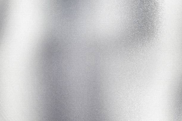 istock Glowing silver metal wall with scratched surface, abstract texture background 1166605990