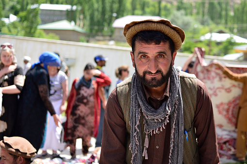 KHOROG, PAMIR MOUNTAINS, TAJIKISTAN - 06 JULY 2019: Portrait of the people of Afghanistan which is trading on the market in Tajikistan in the Pamir Mountains