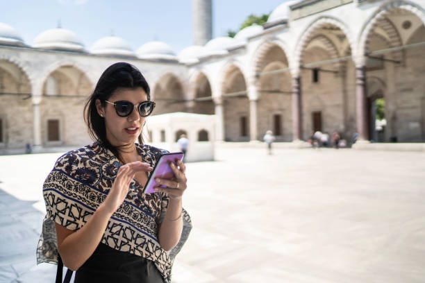 istock Woman using smartphone in a Mosque, Istambul, Turkey 1166610161