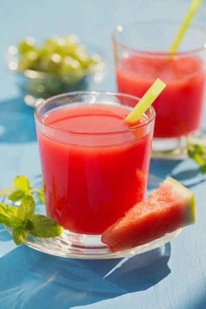 istock Cold fresh watermelon juice on a wooden blue table. 1166610244