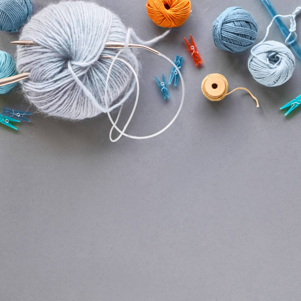 istock Creative knitting hobby background in pastel colors on grey paper with copy-space 1166611412