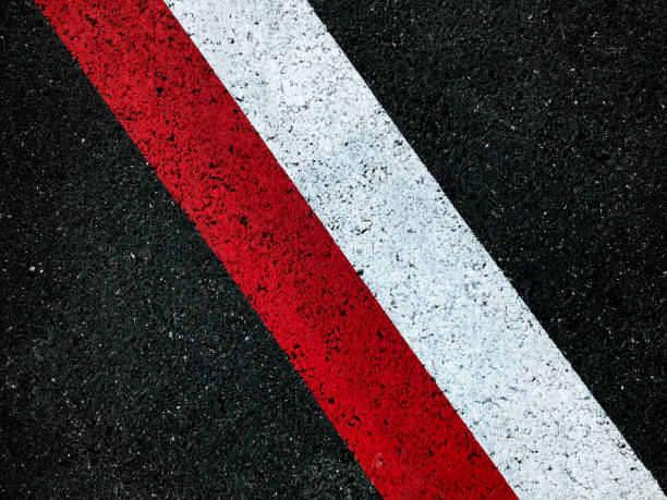 istock Asphalt road with red and white line, close up 1166611881