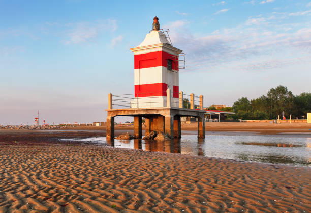 Lignano Sabbiadoro Lighthouse with beach at sunrise