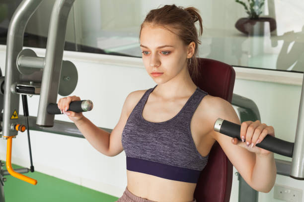 istock Girl does machine chest press exercise 1166612115