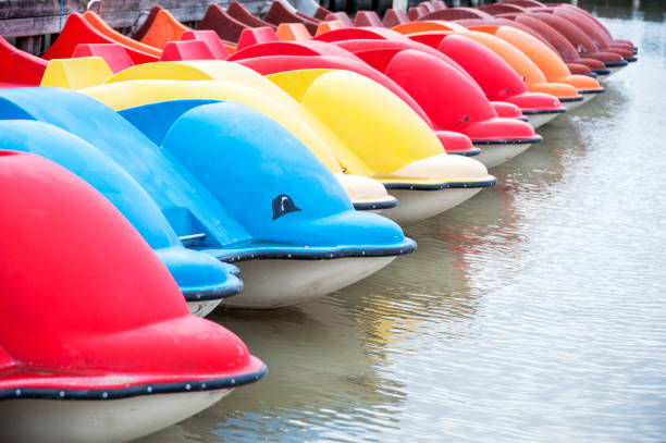 istock Colourful boats in shape of dolphins 1166615448