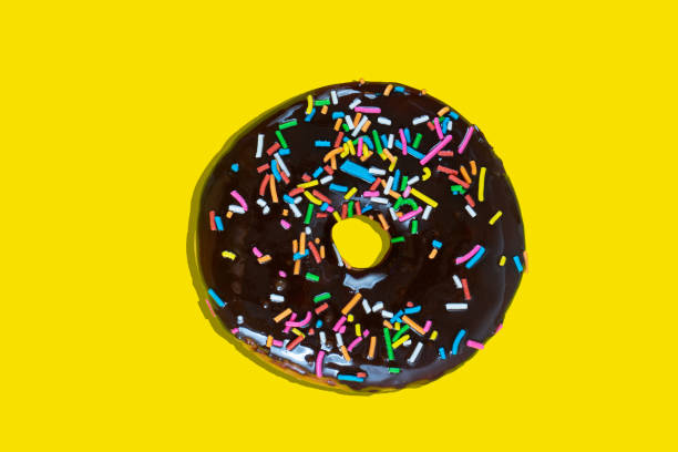 istock Sweet donut with icing on yellow background 1166615573