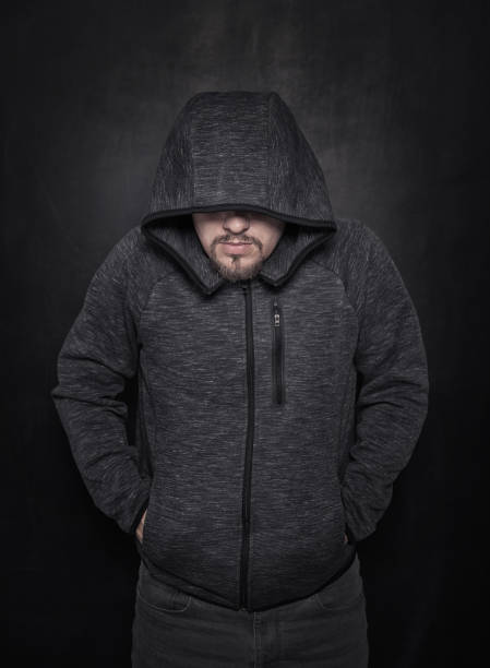 istock Mystery unknown man in hood on dark 1166615615