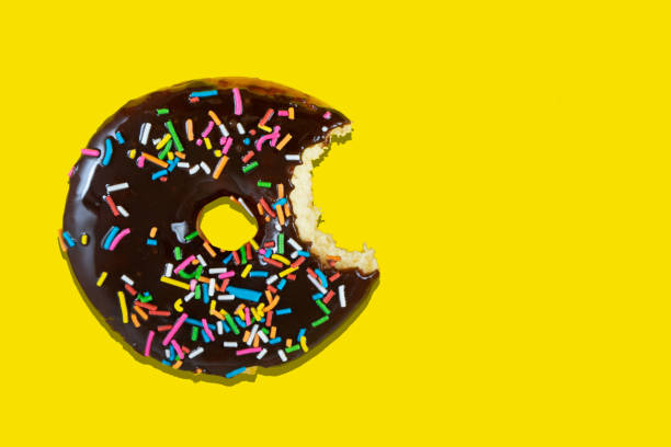 istock Sweet donut with icing on yellow background 1166615695