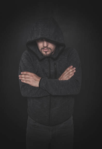 istock Mystery unknown man in hood on dark 1166615721