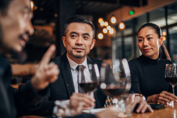 istock Business people drinking sitting in restaurant 1166616397